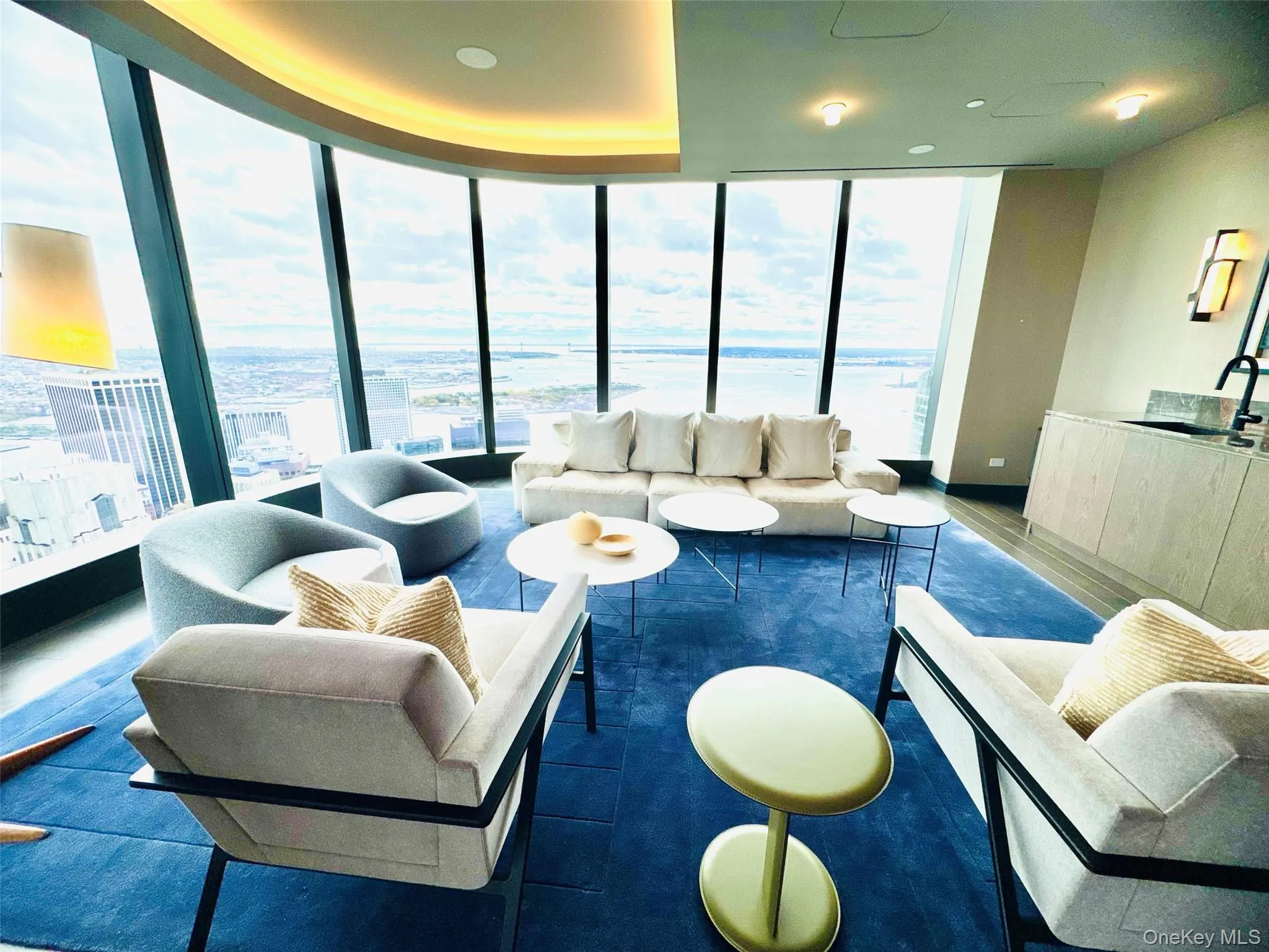 Living area featuring floor to ceiling windows and a water view Living area featuring floor to ceiling windows and a water view