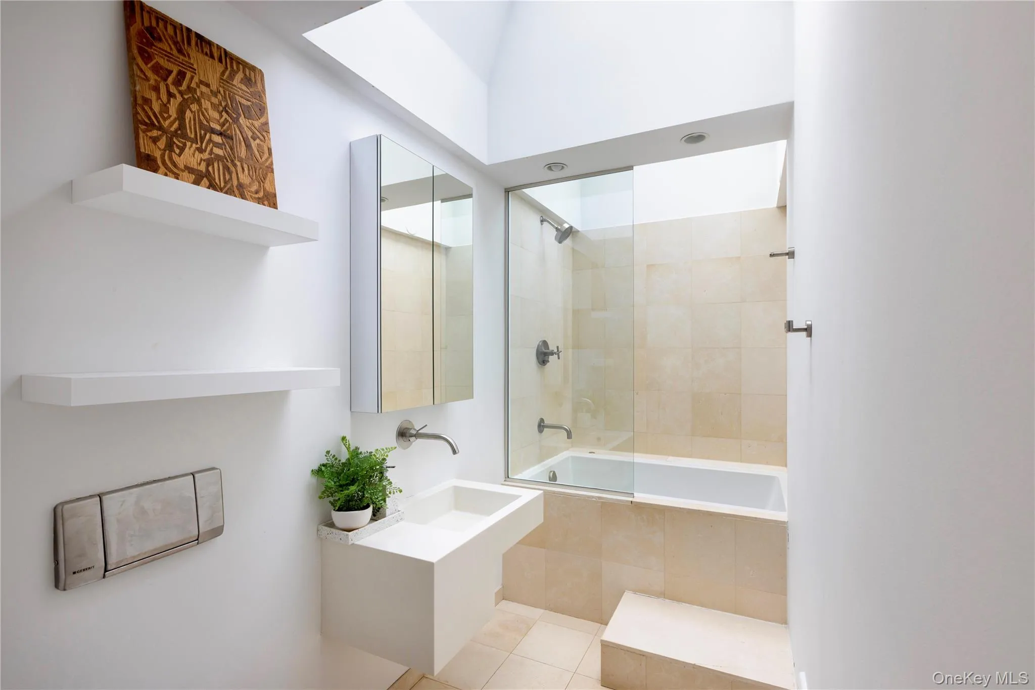 Full bath featuring vanity, tiled shower / bath combo, and light tile patterned floors Full bath featuring vanity, tiled shower / bath combo, and light tile patterned floors