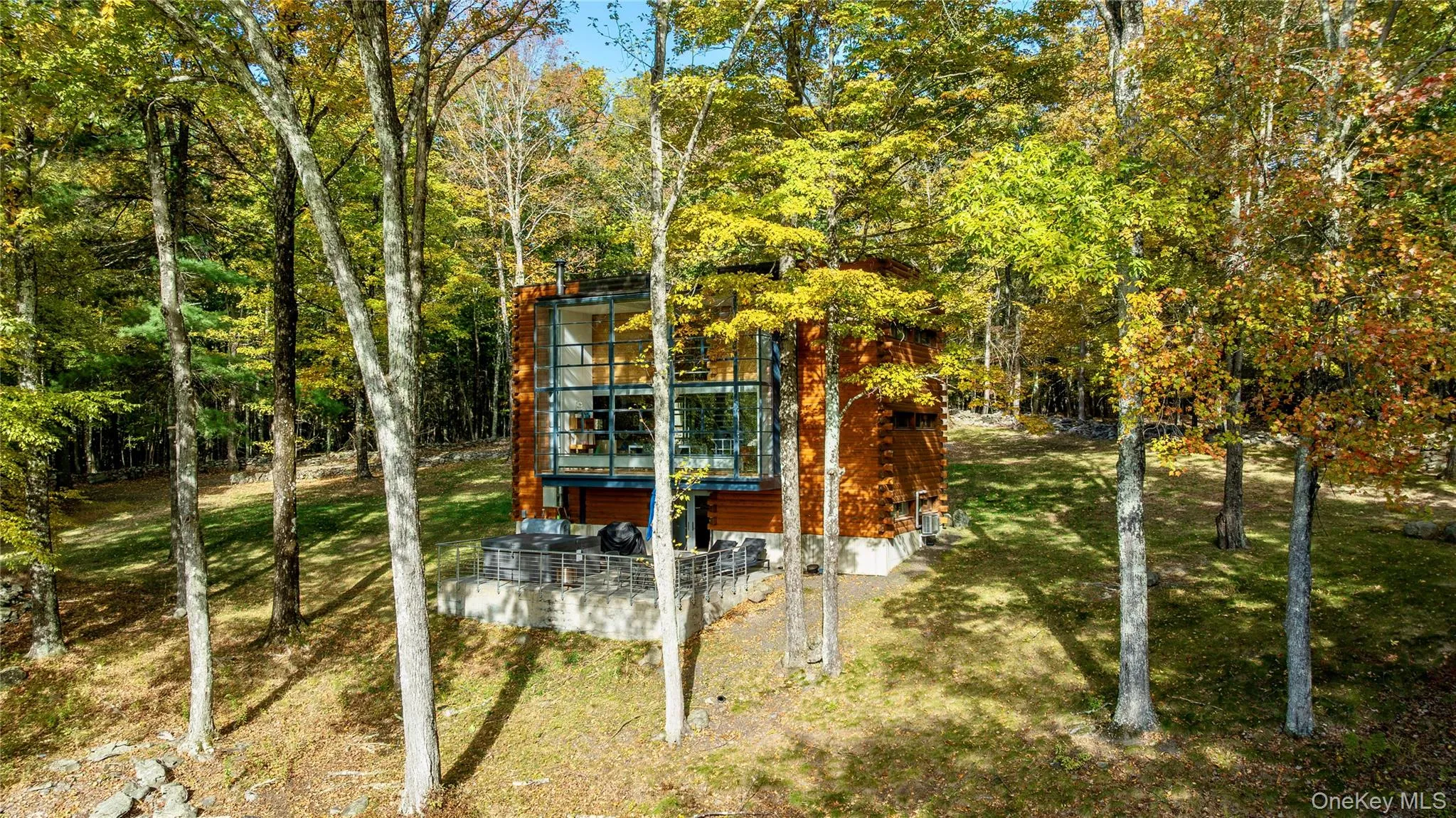 View of green lawn with a patio and a wooded view View of green lawn with a patio and a wooded view