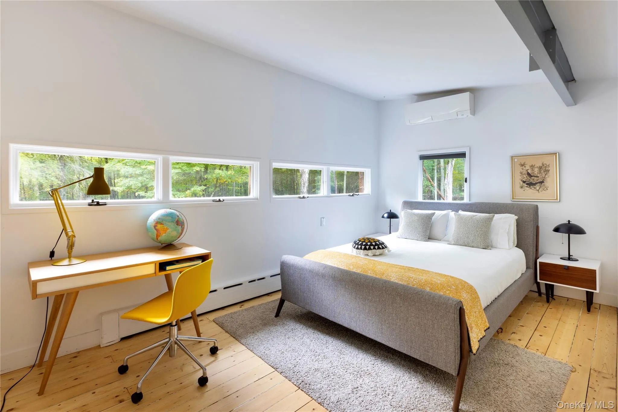 Bedroom with hardwood / wood-style flooring, a desk, a wall mounted AC, and baseboard heating Bedroom with hardwood / wood-style flooring, a desk, a wall mounted AC, and baseboard heating