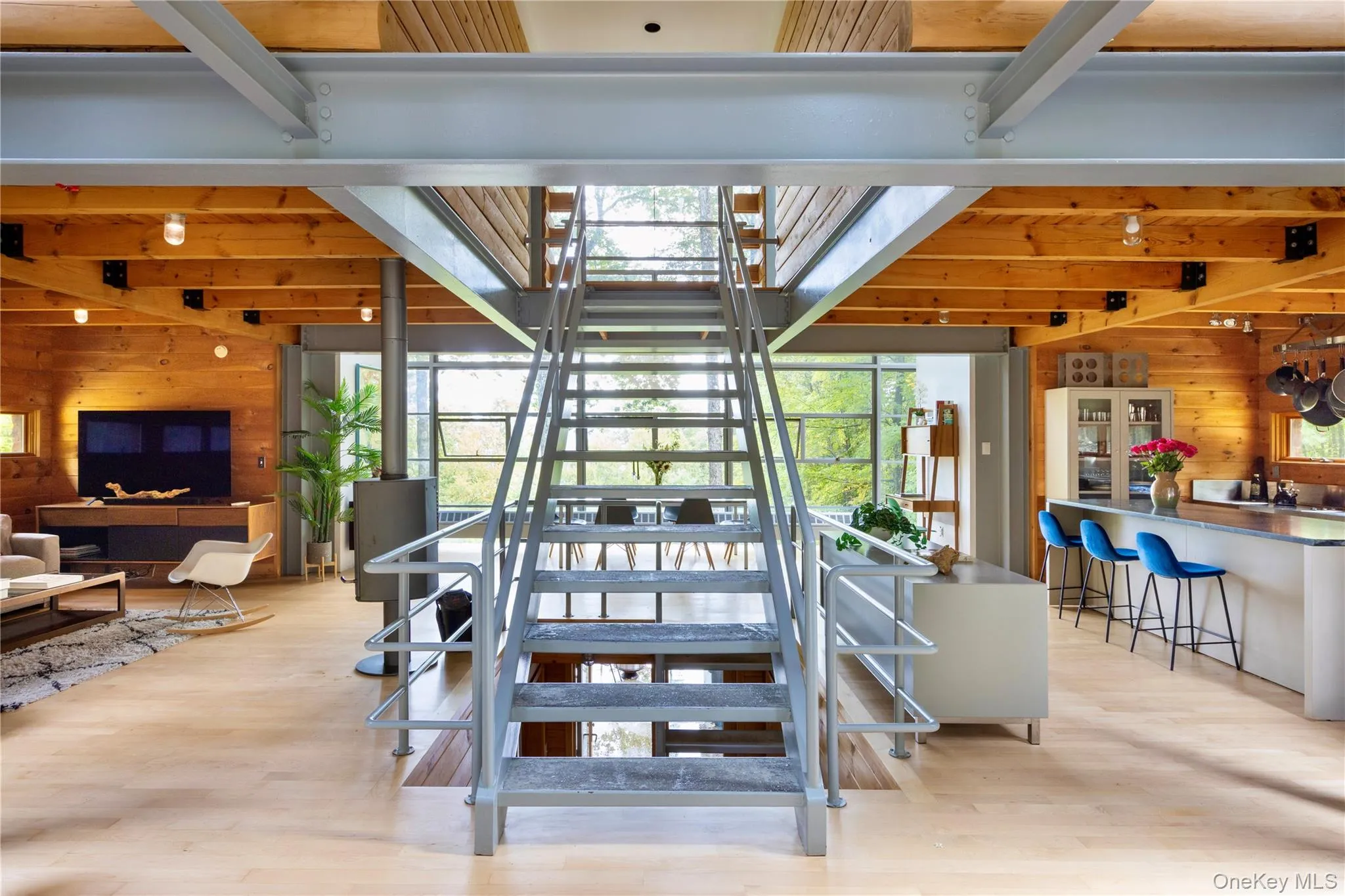 Stairway with wood walls, beamed ceiling, and wood finished floors Stairway with wood walls, beamed ceiling, and wood finished floors
