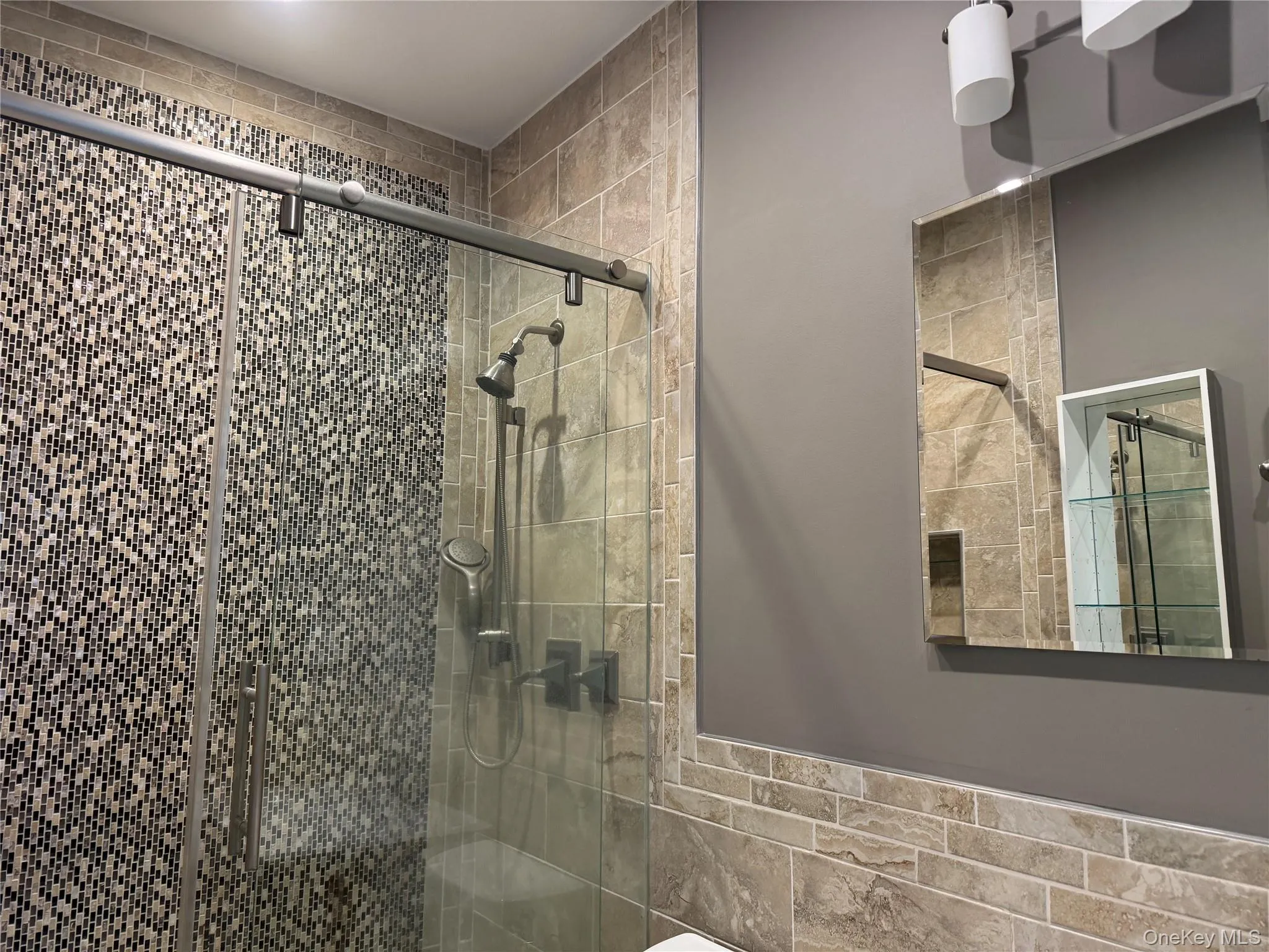 Full bath featuring a shower stall Full bath featuring a shower stall