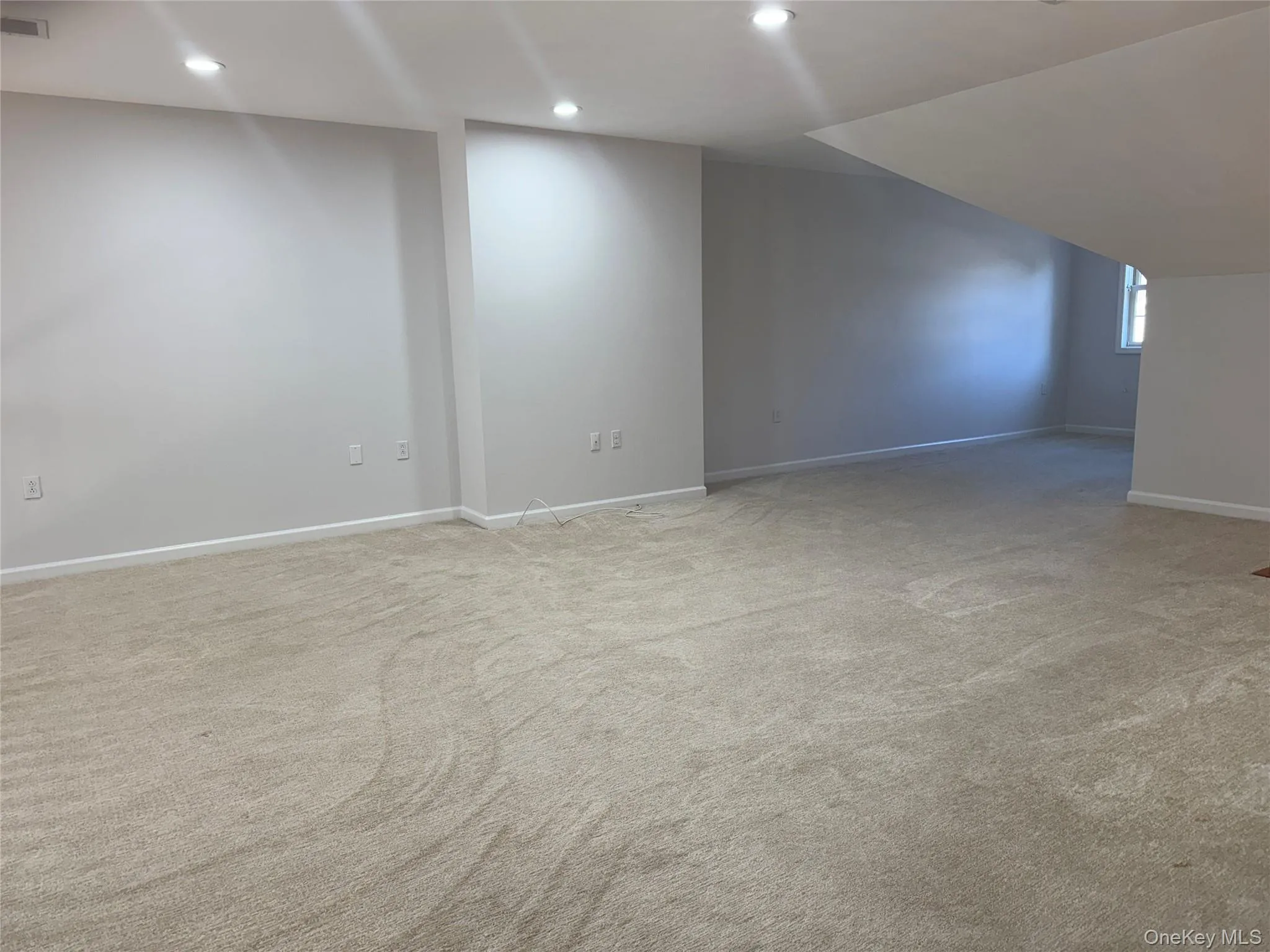 Additional living space with recessed lighting and light colored carpet Additional living space with recessed lighting and light colored carpet