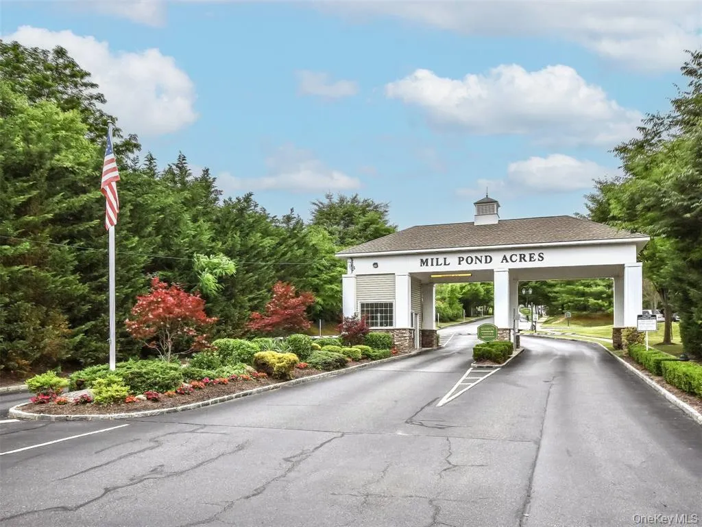 View of asphalt street with curbs and a gated entry View of asphalt street with curbs and a gated entry