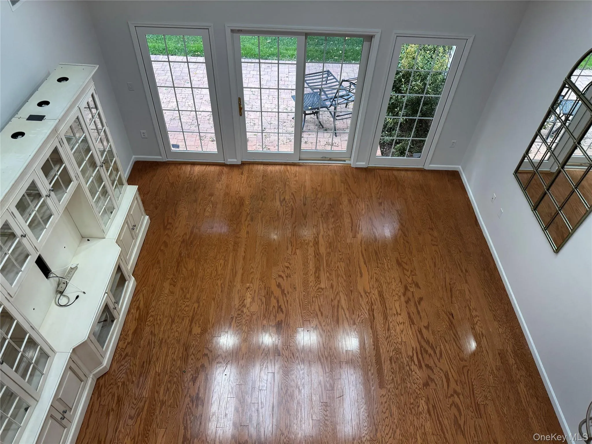 Unfurnished living room with wood finished floors and baseboards Unfurnished living room with wood finished floors and baseboards