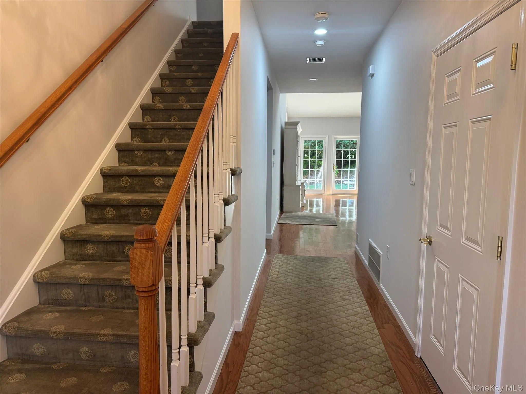 Staircase featuring wood finished floors and recessed lighting Staircase featuring wood finished floors and recessed lighting