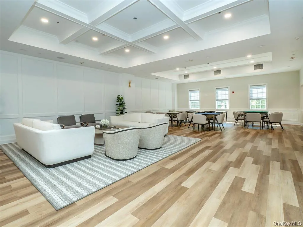 Building lobby featuring a decorative wall, beam ceiling, and coffered ceiling Building lobby featuring a decorative wall, beam ceiling, and coffered ceiling
