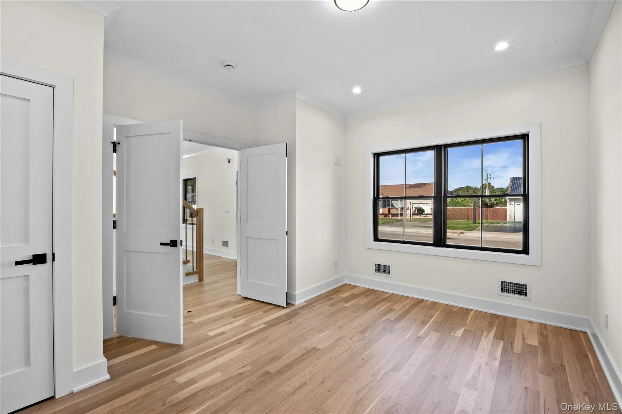 Unfurnished bedroom featuring ornamental molding, light wood-style floors, and recessed lighting Unfurnished bedroom featuring ornamental molding, light wood-style floors, and recessed lighting