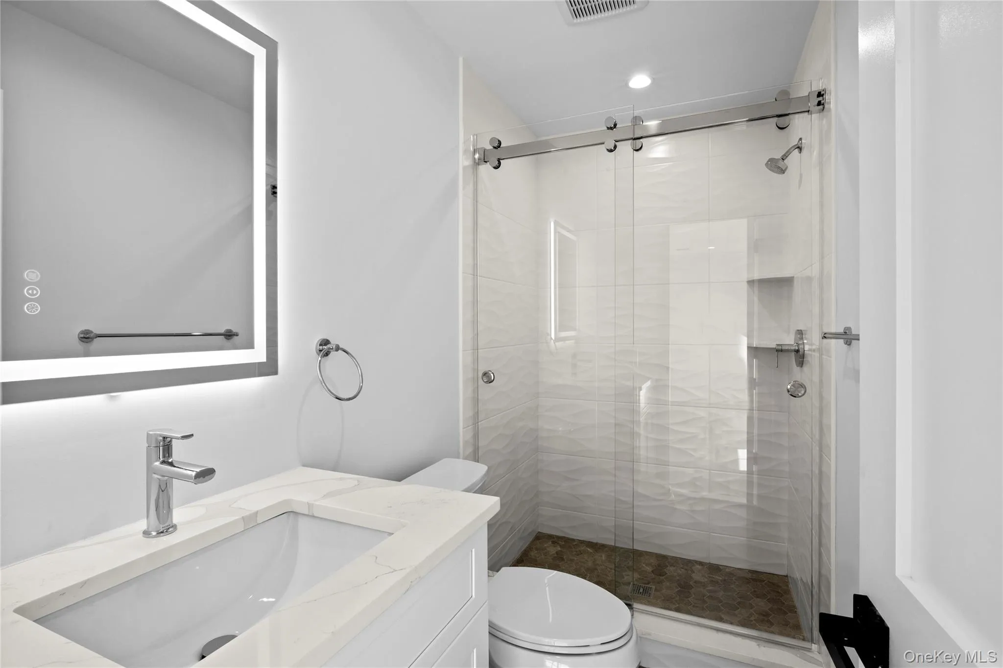 Bathroom with a shower stall and vanity Bathroom with a shower stall and vanity
