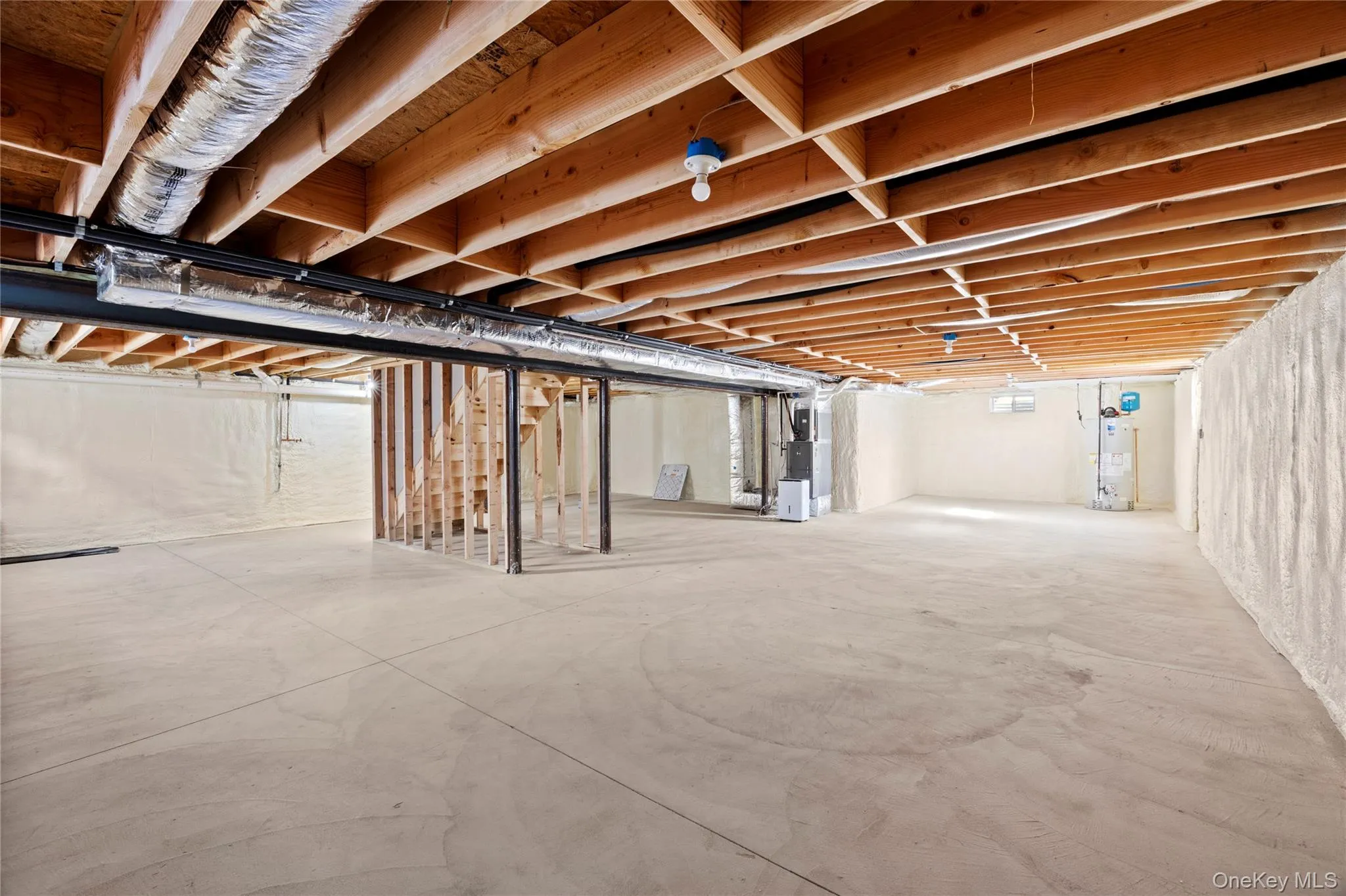 Unfinished basement with heating unit and gas water heater Unfinished basement with heating unit and gas water heater