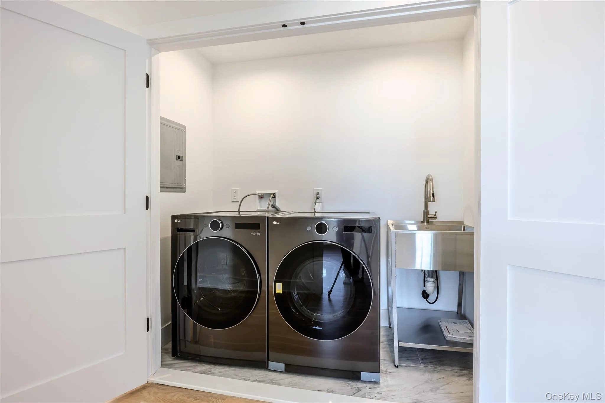 Laundry room with electric panel and washer and dryer Laundry room with electric panel and washer and dryer