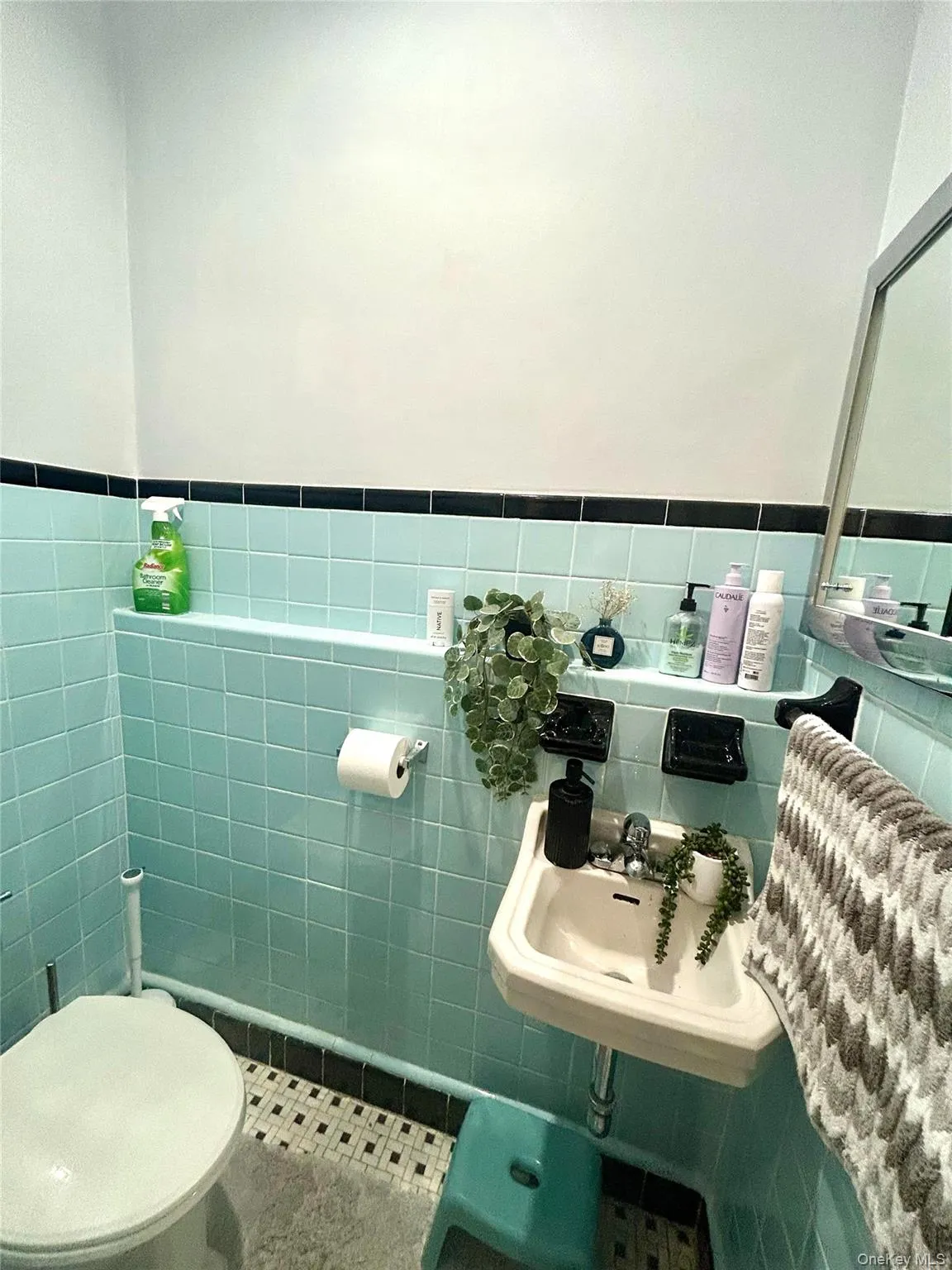 Half bathroom with tile walls, a wainscoted wall, and tile patterned floors Half bathroom with tile walls, a wainscoted wall, and tile patterned floors
