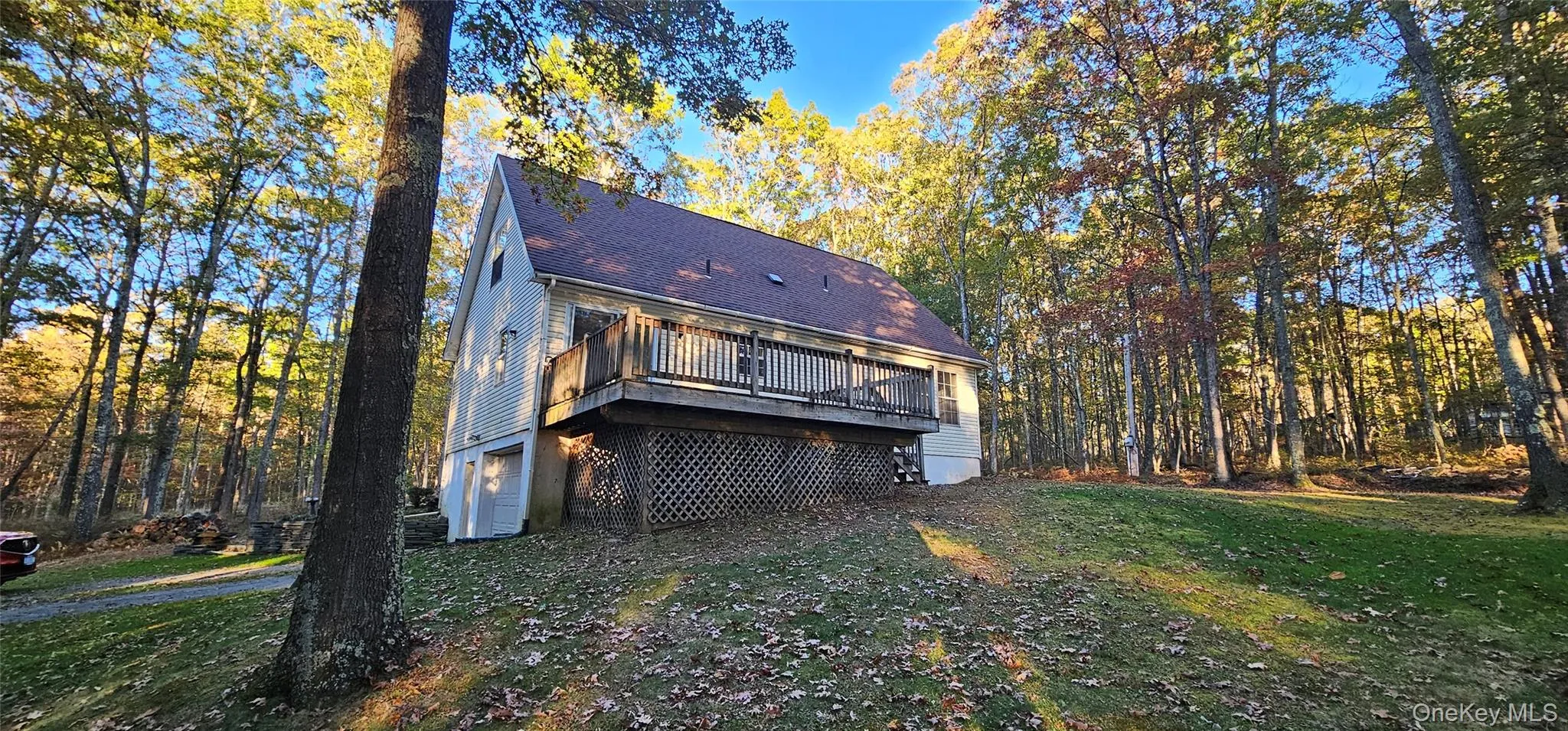 Rear view of house featuring a yard, a shingled roof, and a deck Rear view of house featuring a yard, a shingled roof, and a deck