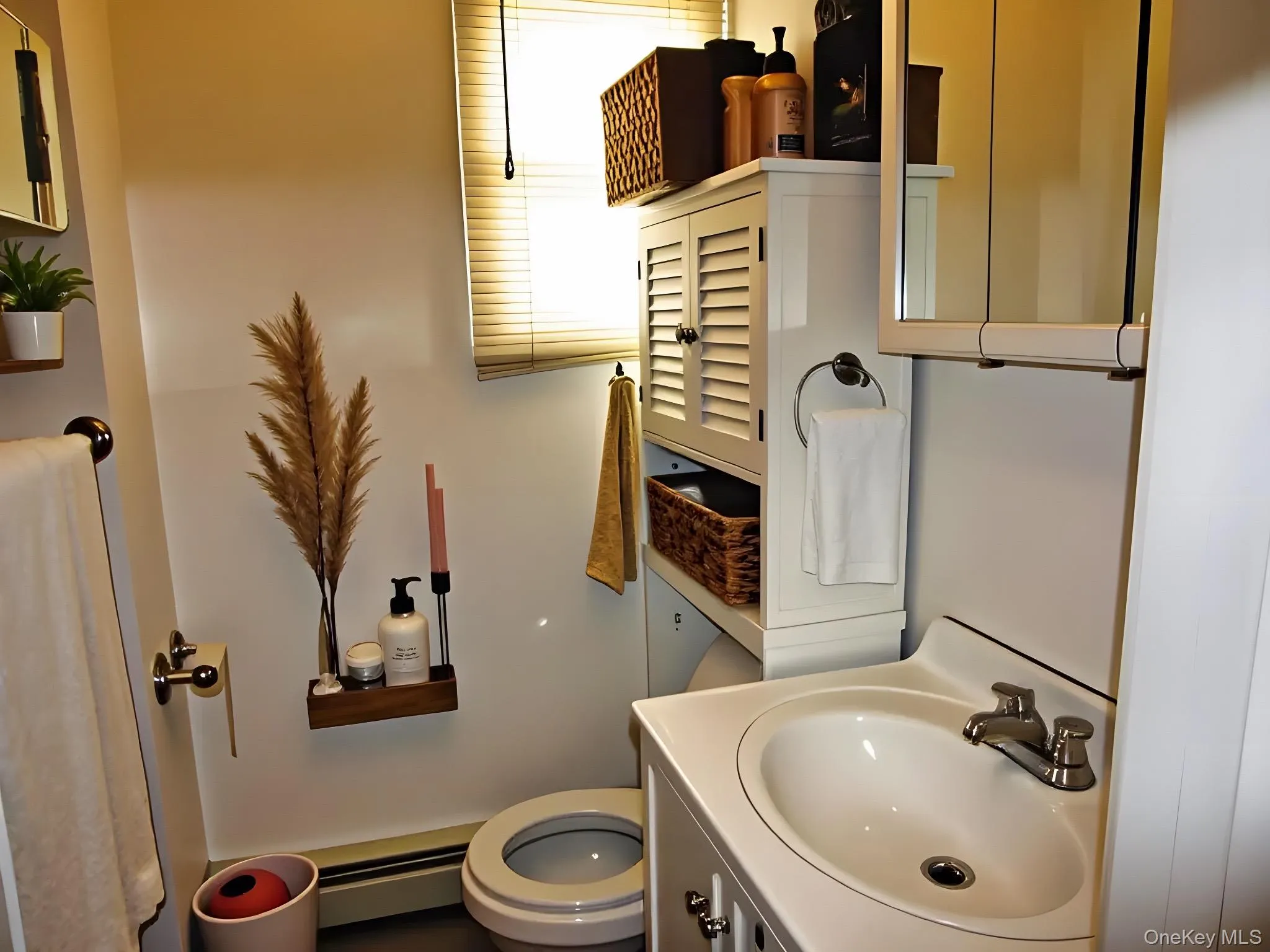 Half bathroom with vanity and baseboard heating Half bathroom with vanity and baseboard heating