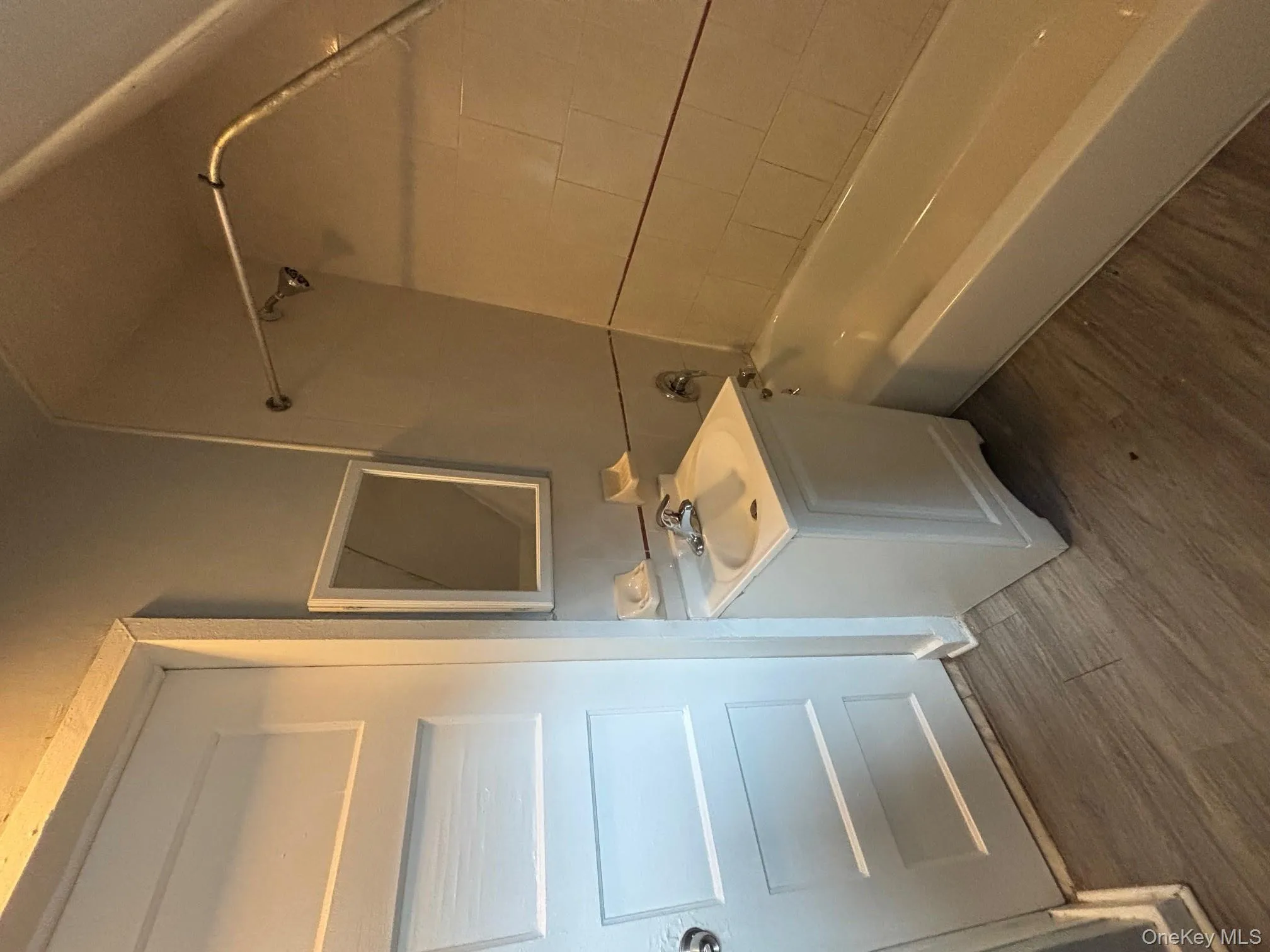 Bathroom with vanity, dark wood finished floors, and shower combination Bathroom with vanity, dark wood finished floors, and shower combination