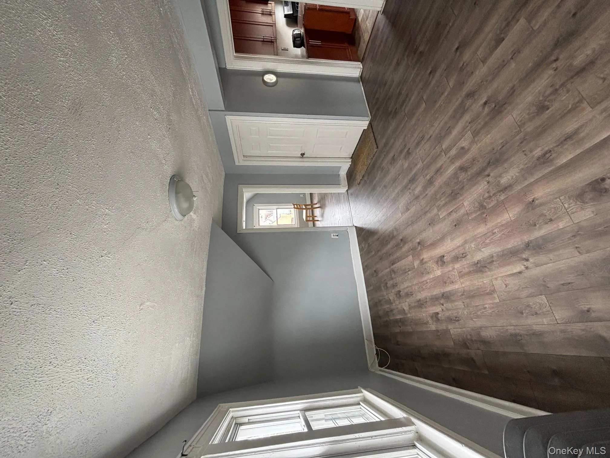 Additional living space featuring a textured ceiling, dark wood-style floors, and lofted ceiling Additional living space featuring a textured ceiling, dark wood-style floors, and lofted ceiling