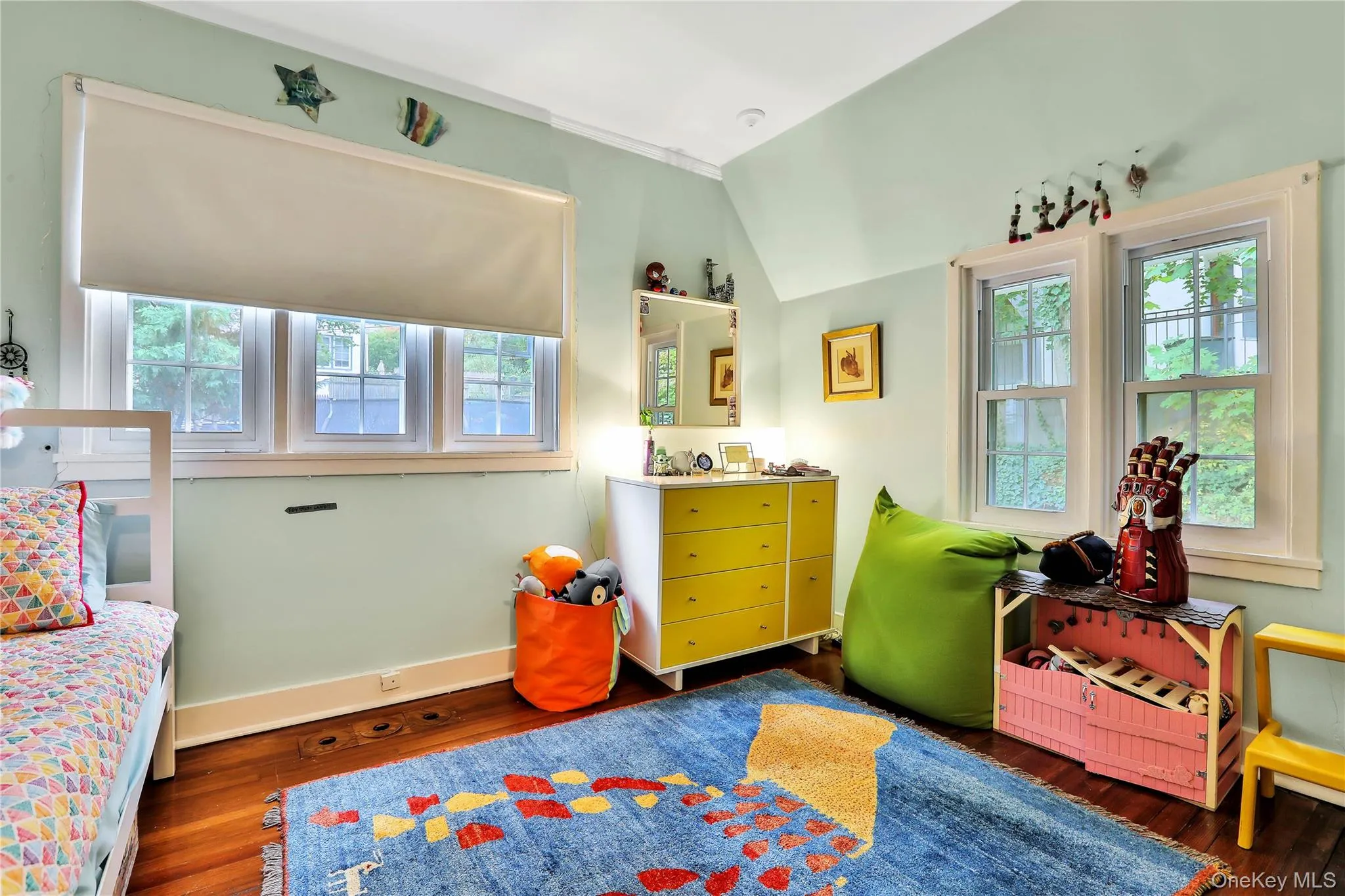 Bedroom featuring hardwood flooring and lofted ceiling Bedroom featuring hardwood flooring and lofted ceiling