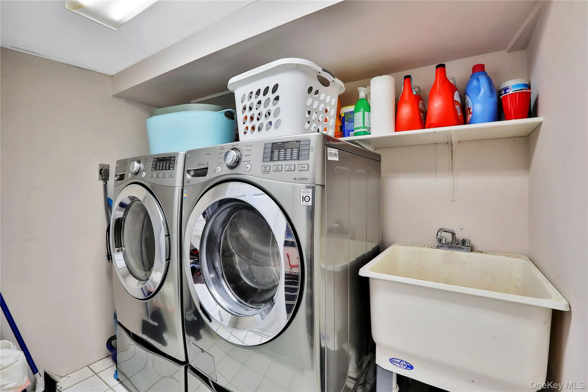 Laundry room with separate washer and dryer and tile floors Laundry room with separate washer and dryer and tile floors