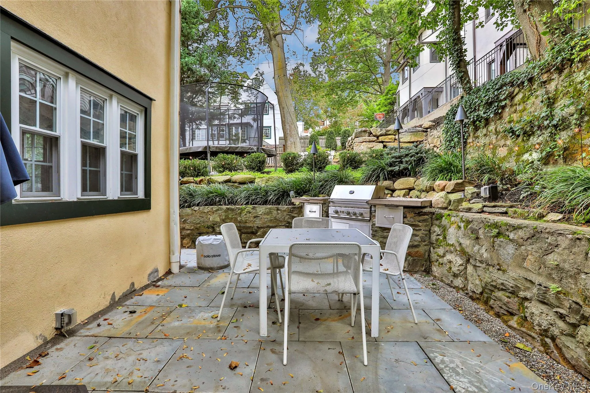 View of patio / terrace with outdoor dining area and area for grilling View of patio / terrace with outdoor dining area and area for grilling