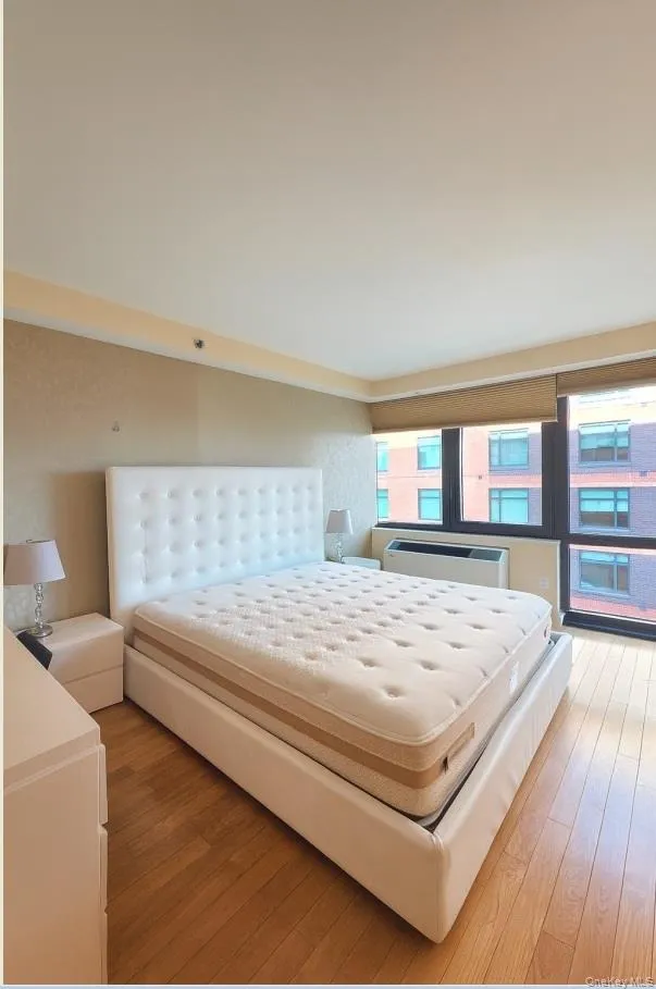 Bedroom with light wood-style flooring Bedroom with light wood-style flooring