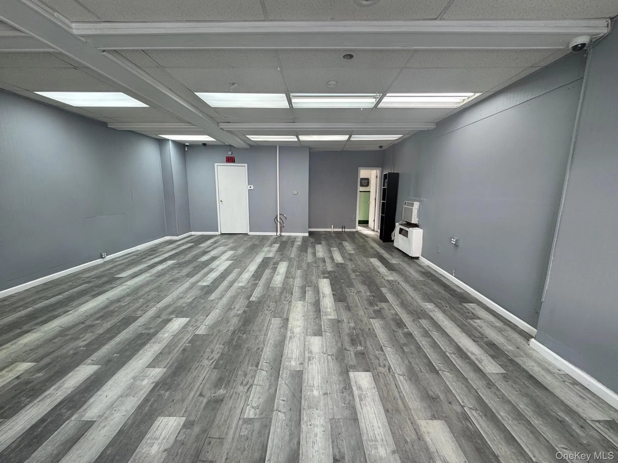 Unfurnished room featuring wood finished floors Unfurnished room featuring wood finished floors