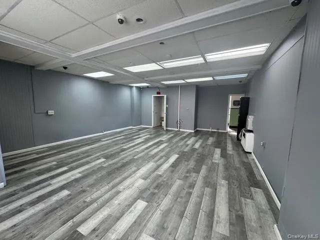 Empty room featuring dark wood-style flooring and baseboards Empty room featuring dark wood-style flooring and baseboards