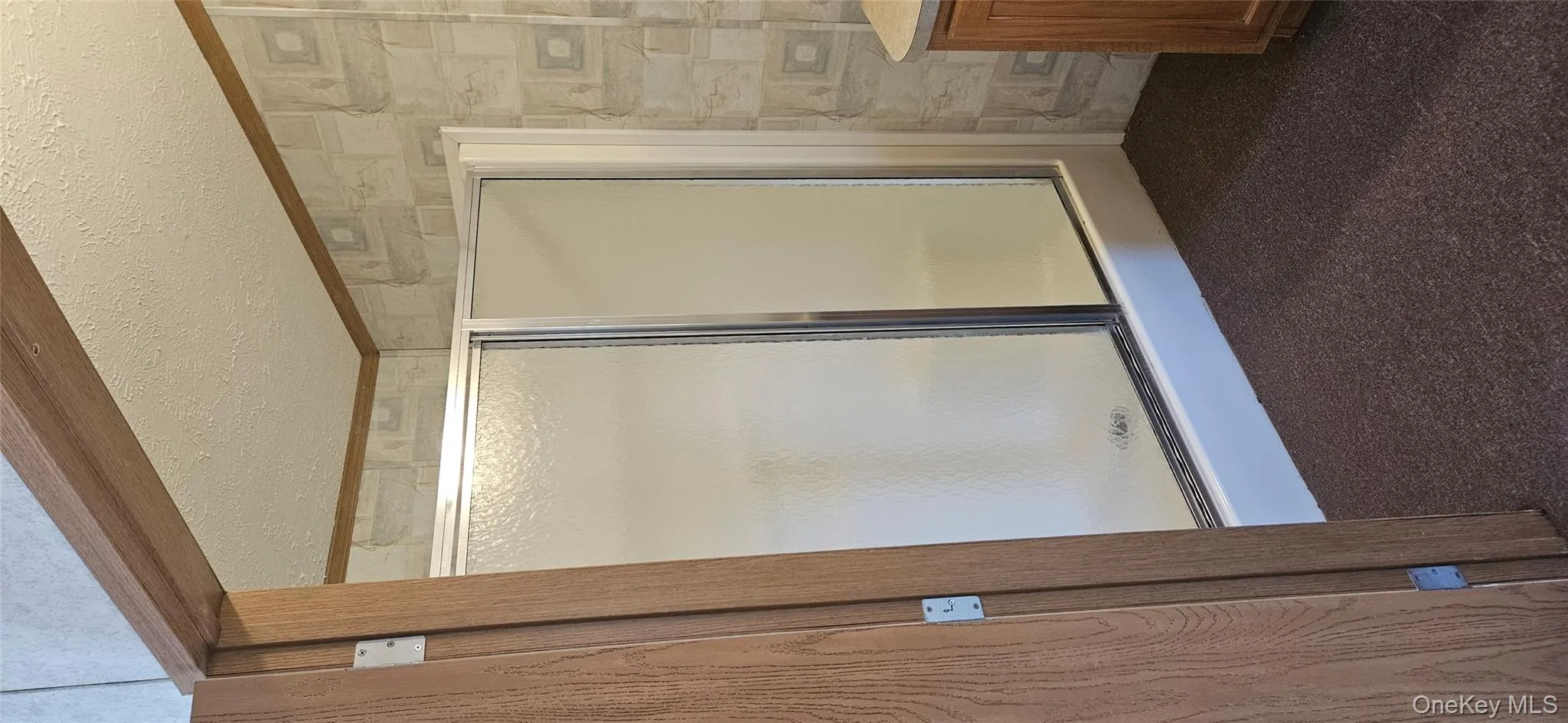 Full bath featuring a textured ceiling, dark colored carpet, a stall shower, and vanity Full bath featuring a textured ceiling, dark colored carpet, a stall shower, and vanity