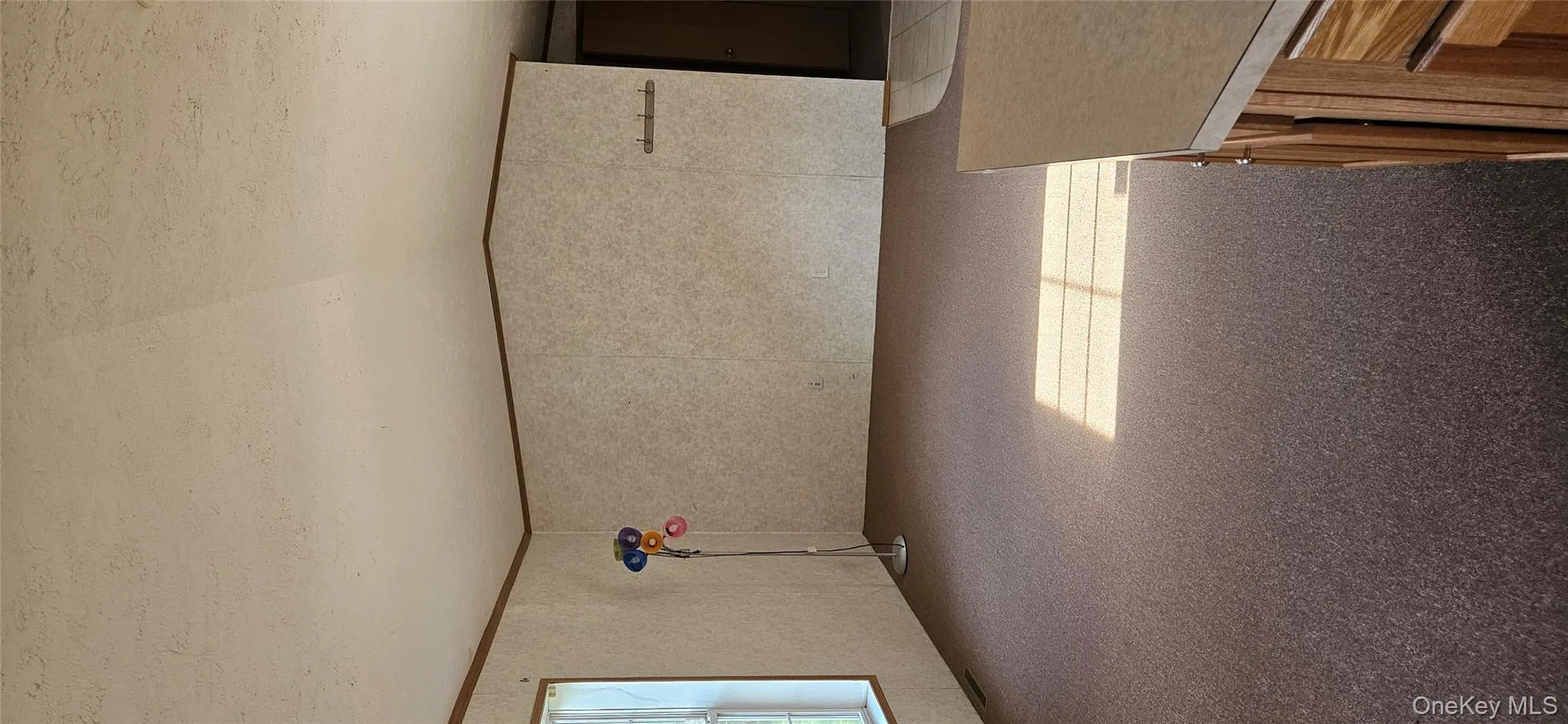 Empty room with carpet flooring, a textured ceiling, and vaulted ceiling Empty room with carpet flooring, a textured ceiling, and vaulted ceiling