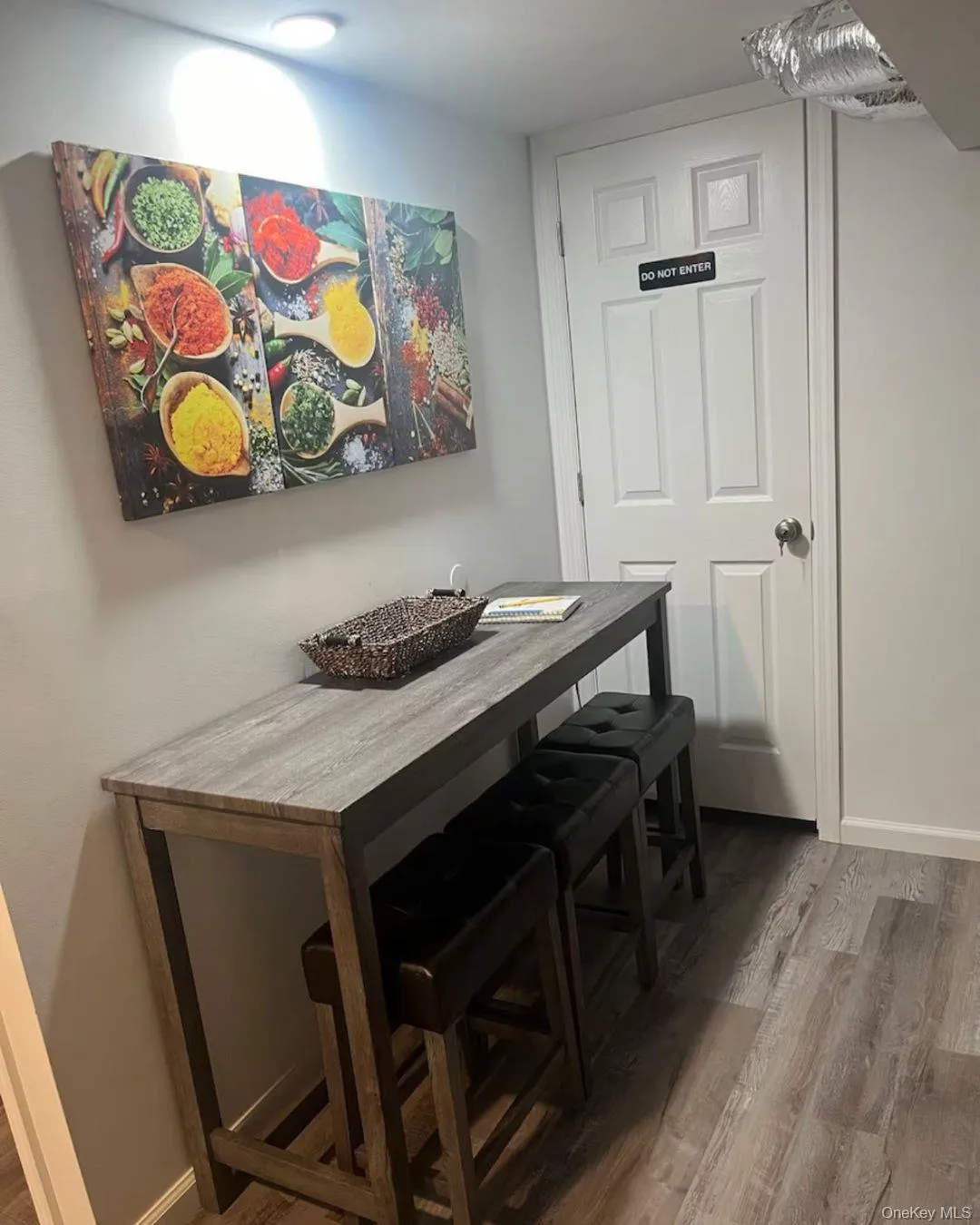 Dining room with dark wood-style flooring and baseboards Dining room with dark wood-style flooring and baseboards