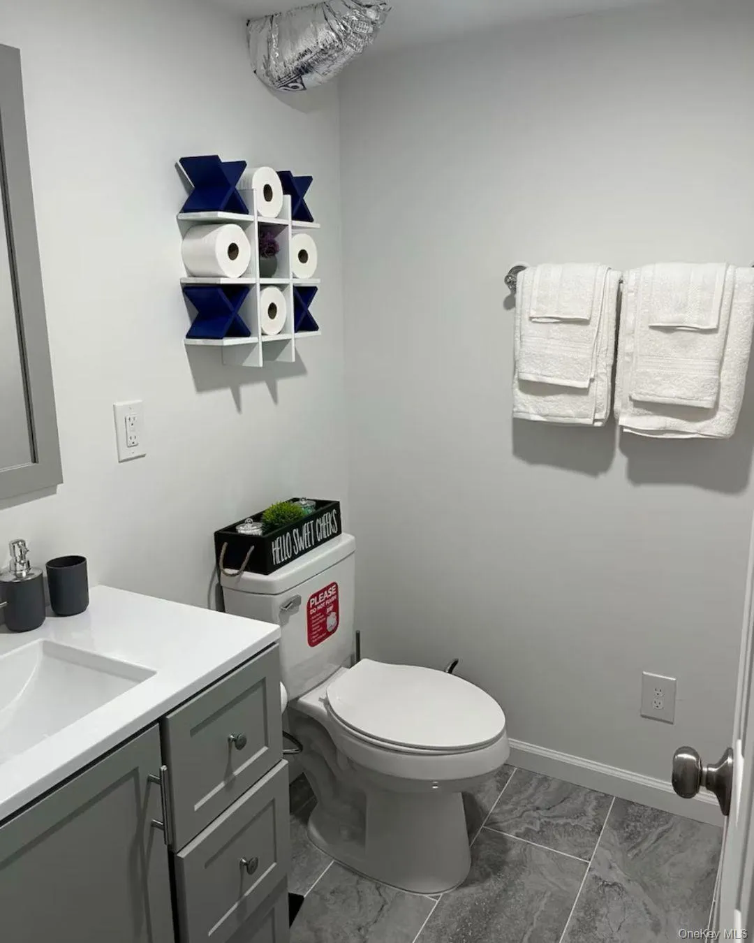 Bathroom with vanity and light marble finish floors Bathroom with vanity and light marble finish floors