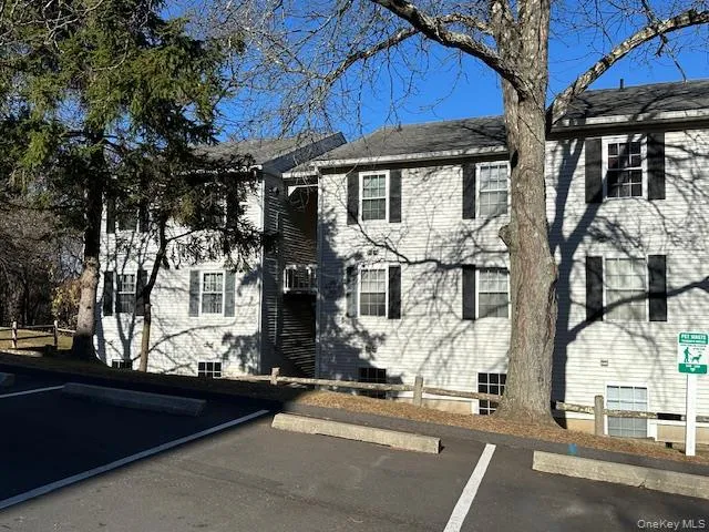 Colonial house featuring uncovered parking Colonial house featuring uncovered parking