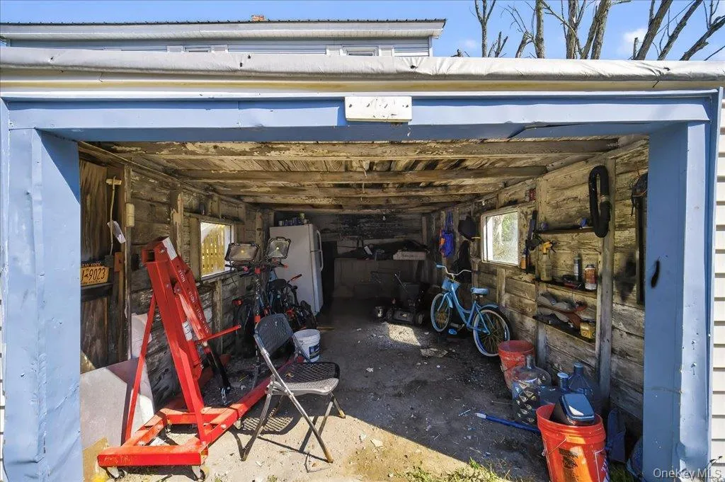 Garage featuring freestanding refrigerator Garage featuring freestanding refrigerator