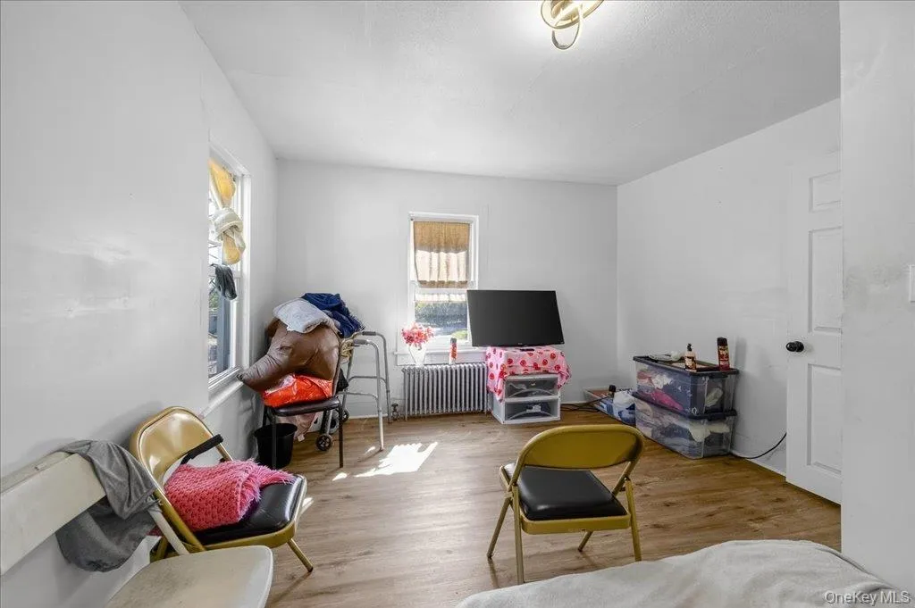 Recreation room featuring wood finished floors and radiator heating unit Recreation room featuring wood finished floors and radiator heating unit