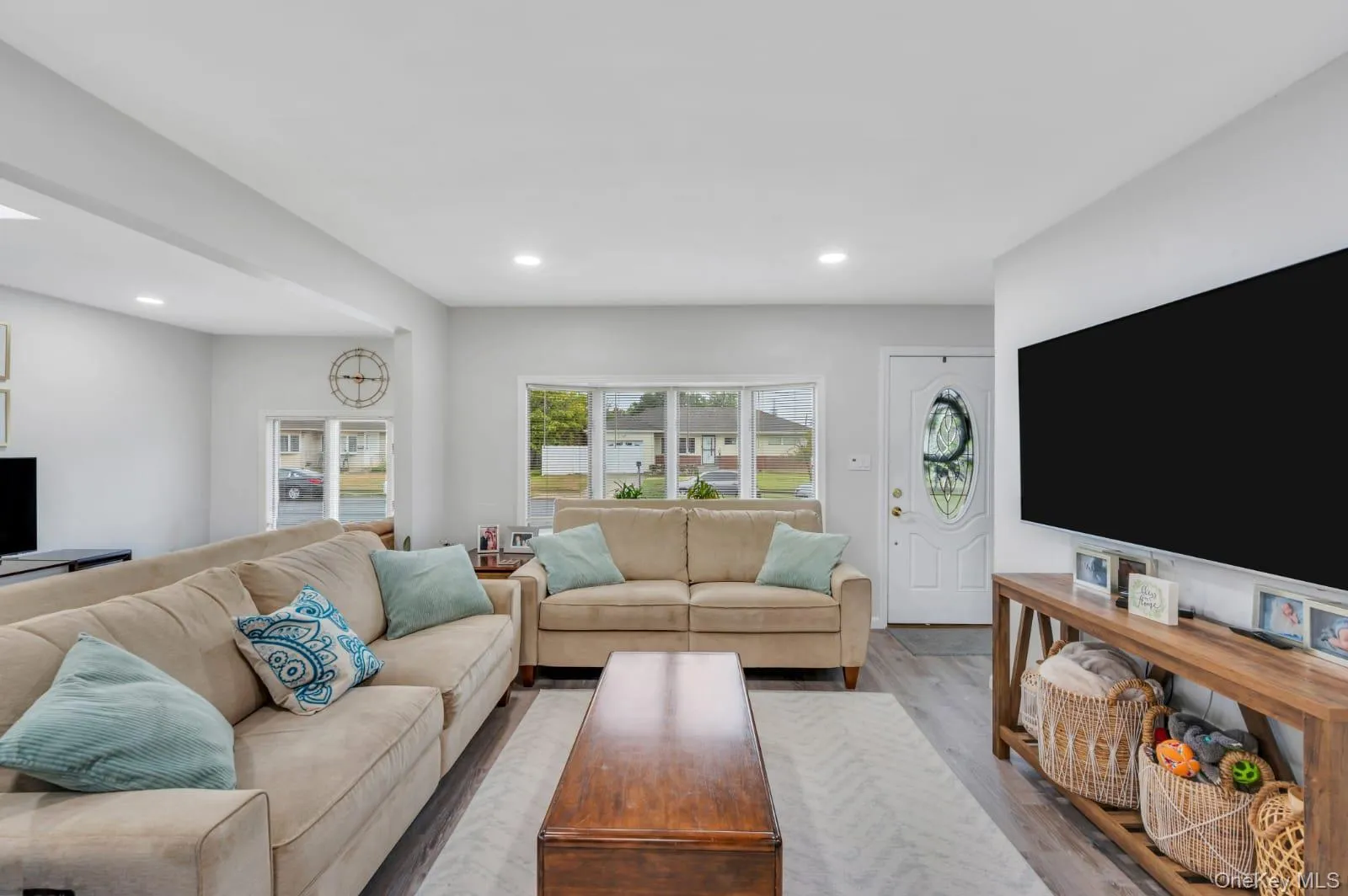 Living area with wood finished floors and recessed lighting Living area with wood finished floors and recessed lighting