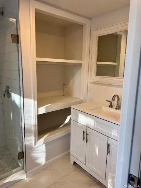 Full bathroom featuring vanity and a stall shower Full bathroom featuring vanity and a stall shower