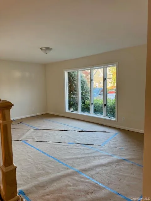 Unfurnished room with baseboards and walls of glass Unfurnished room with baseboards and walls of glass