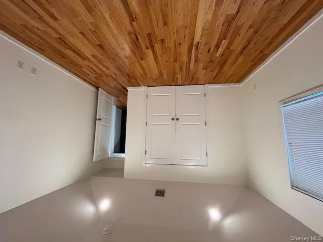 Bedroom 3 with wood finished floors and a closet Bedroom 3 with wood finished floors and a closet