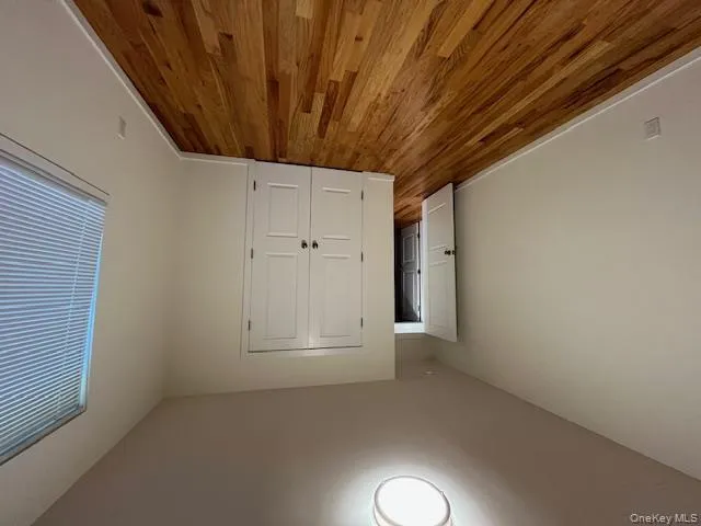 Bedroom 2 with wood finished floors and a closet Bedroom 2 with wood finished floors and a closet