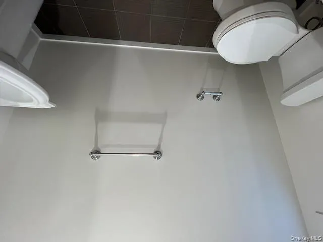 Powder room featuring baseboards and dark tile patterned floors Powder room featuring baseboards and dark tile patterned floors