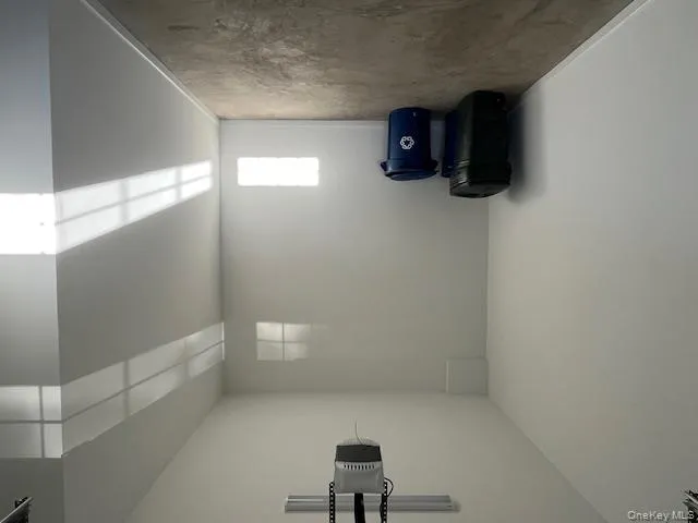 Garage with a garage door opener and baseboards Garage with a garage door opener and baseboards