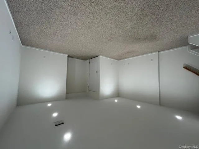 Below grade area featuring light colored carpet, recessed lighting, and stairs Below grade area featuring light colored carpet, recessed lighting, and stairs