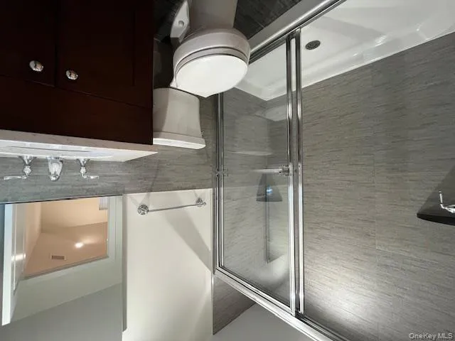 Full bath with tile walls, vanity, and a shower stall Full bath with tile walls, vanity, and a shower stall