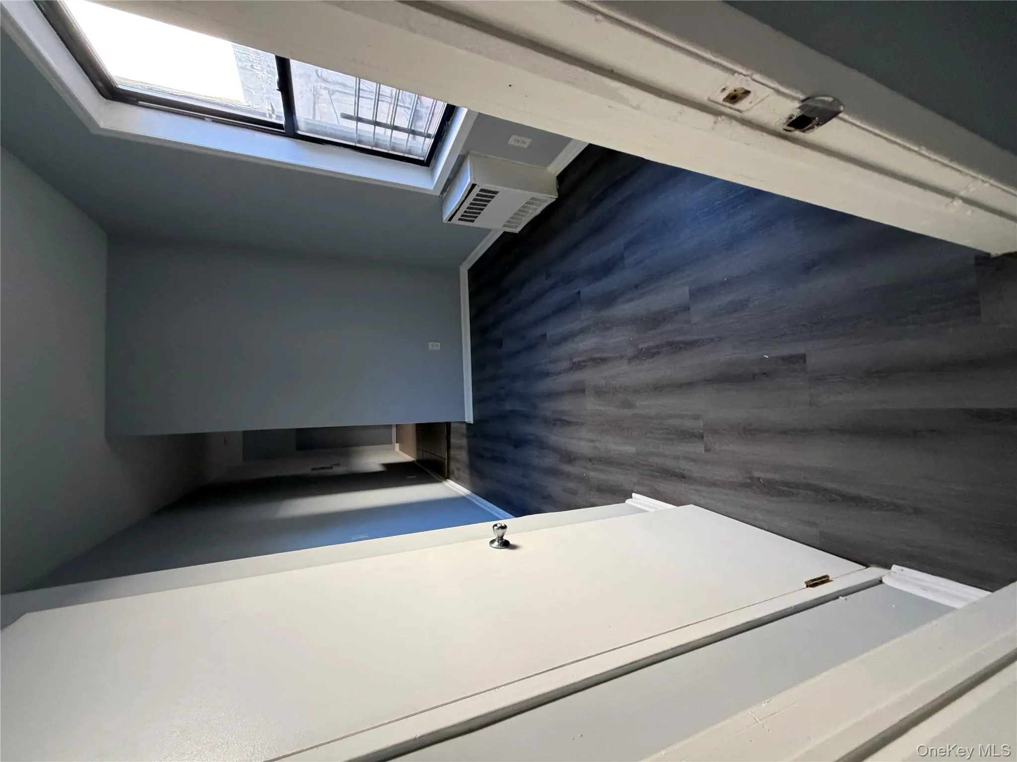 Unfurnished bedroom with dark wood-type flooring and baseboards Unfurnished bedroom with dark wood-type flooring and baseboards