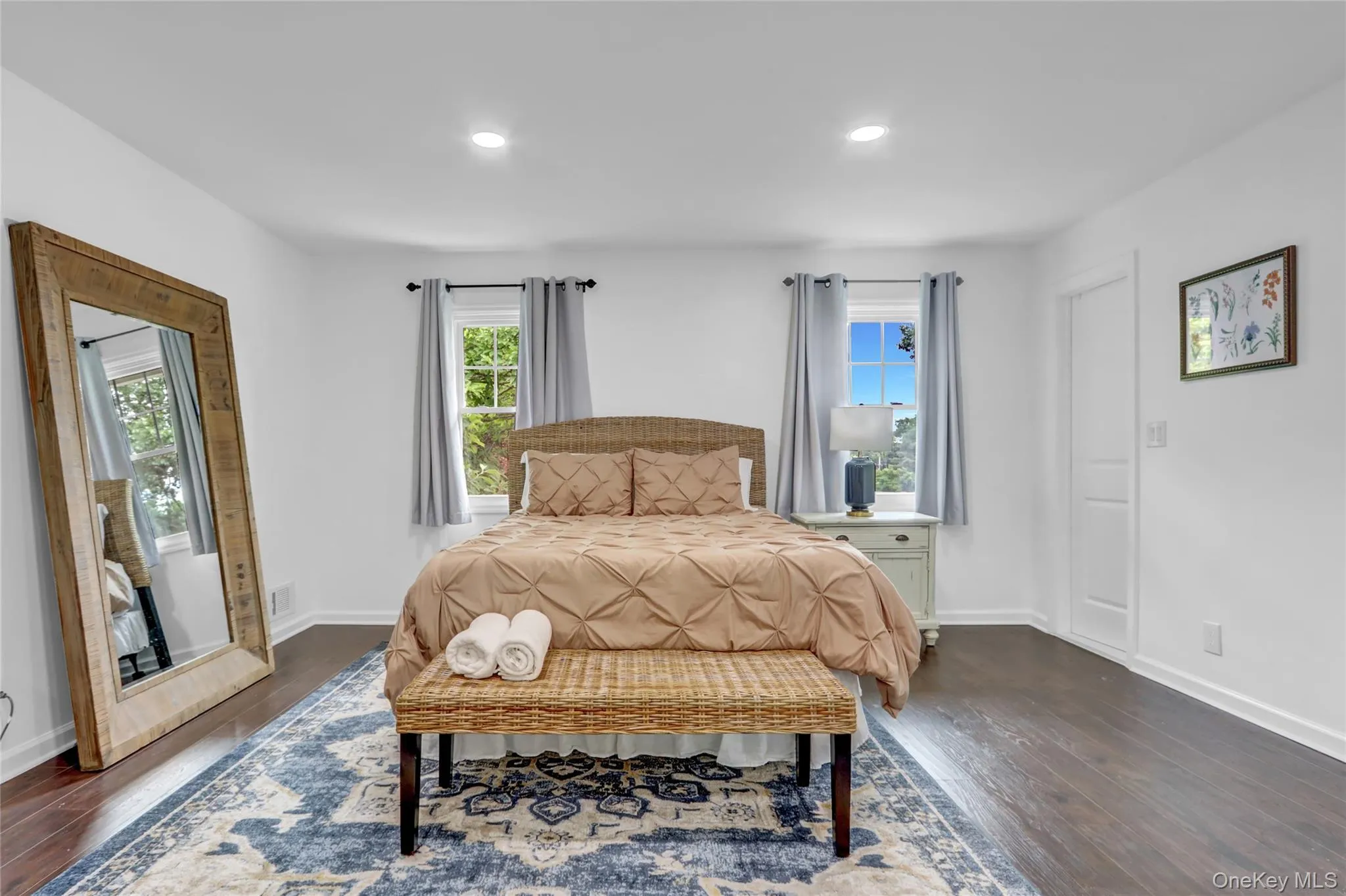 Bedroom featuring multiple windows, dark wood-type flooring, and recessed lighting Bedroom featuring multiple windows, dark wood-type flooring, and recessed lighting