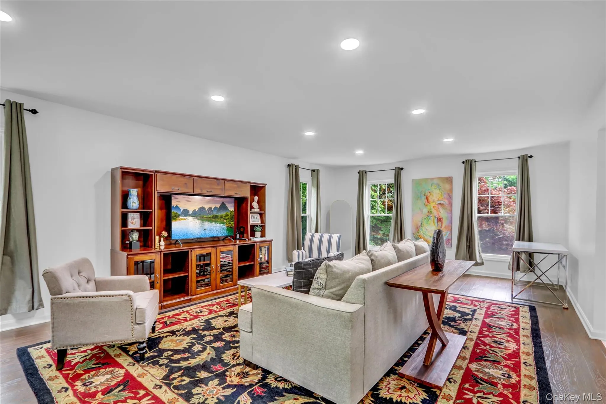 Living room with wood finished floors and recessed lighting Living room with wood finished floors and recessed lighting
