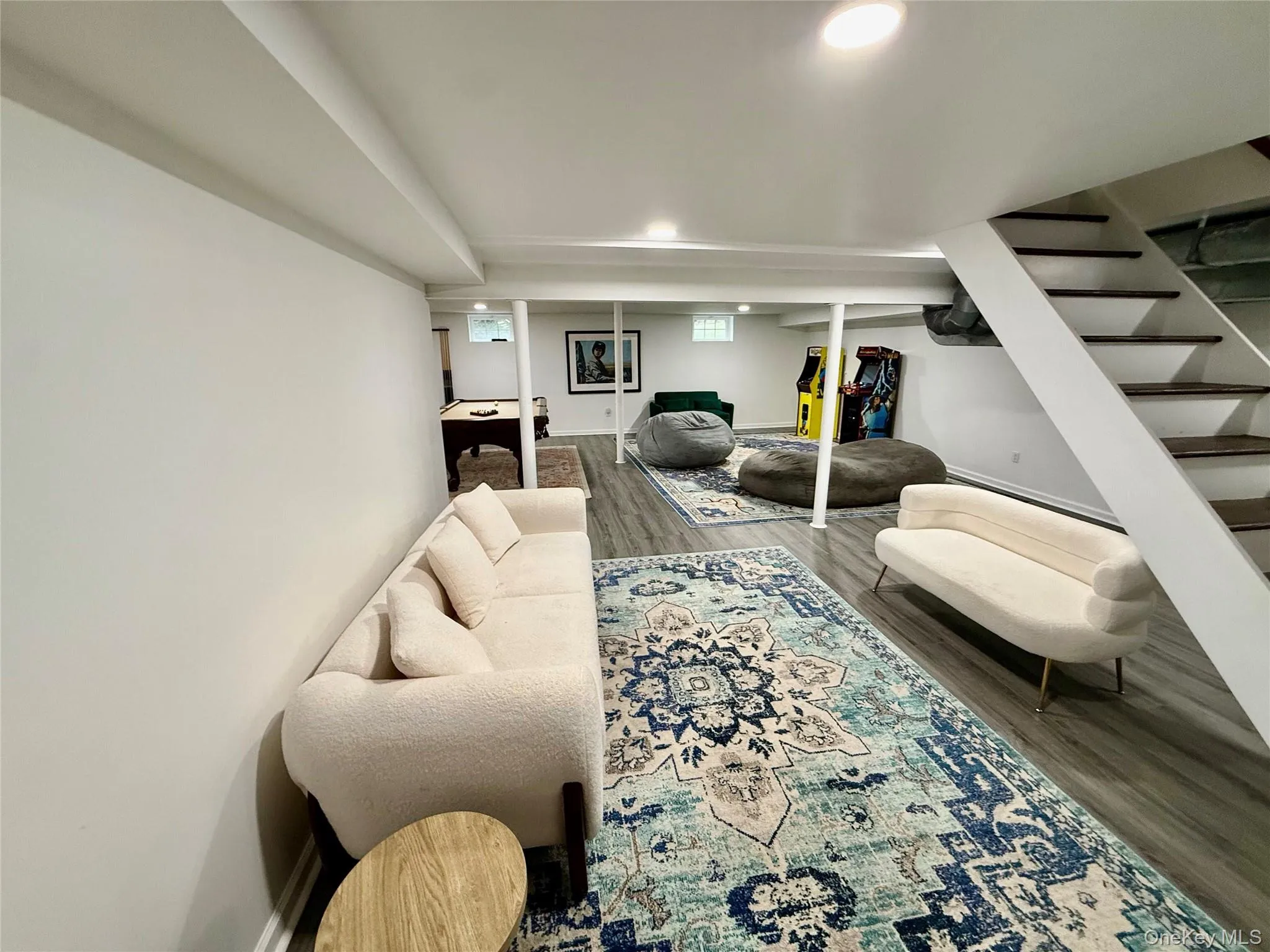 Living area with stairway, wood finished floors, and recessed lighting Living area with stairway, wood finished floors, and recessed lighting