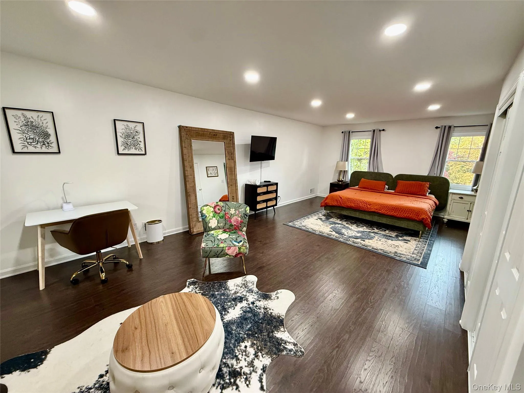 Bedroom featuring recessed lighting, dark wood-type flooring, and an office area Bedroom featuring recessed lighting, dark wood-type flooring, and an office area