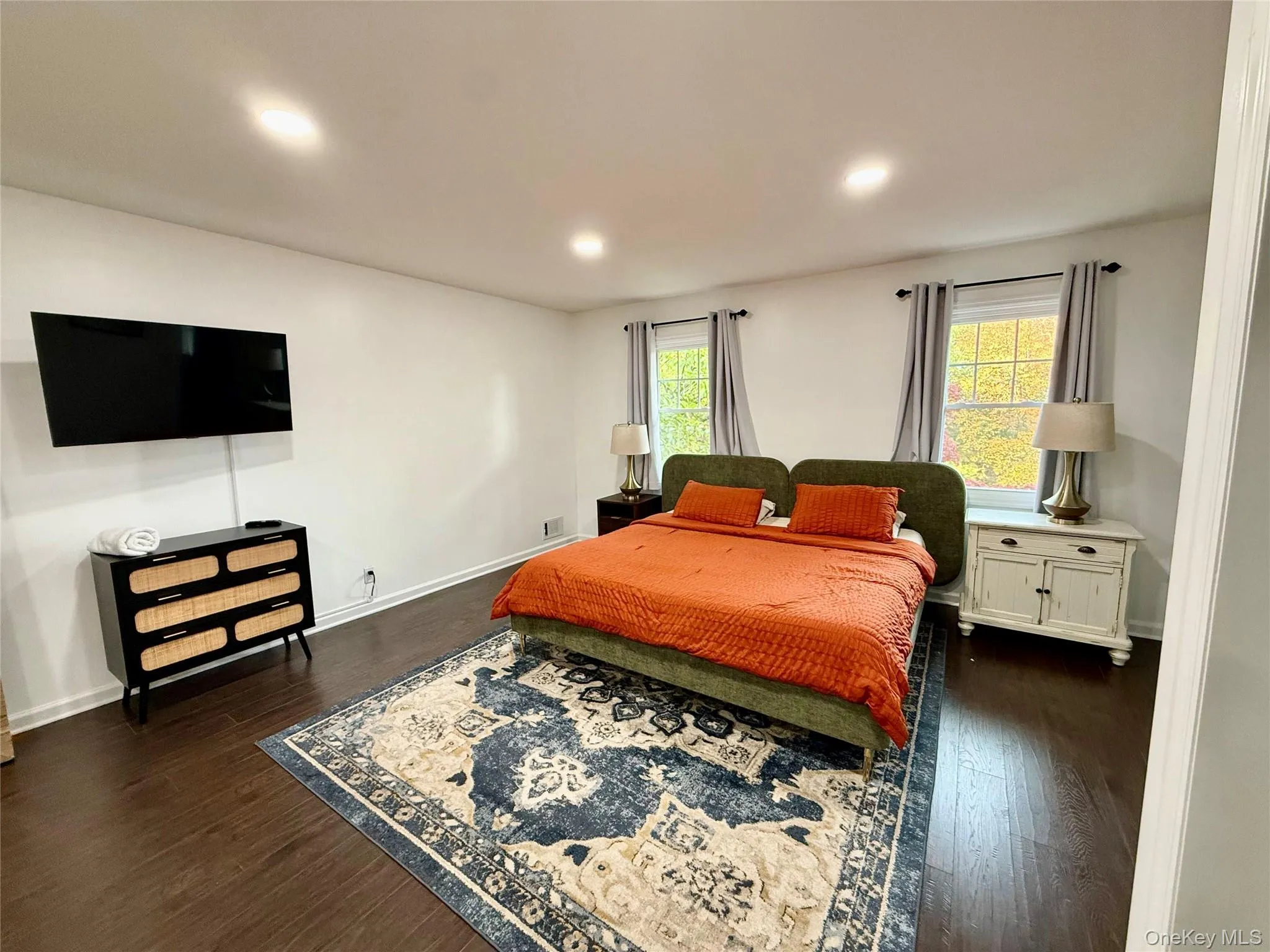 Bedroom with dark wood-style floors and recessed lighting Bedroom with dark wood-style floors and recessed lighting