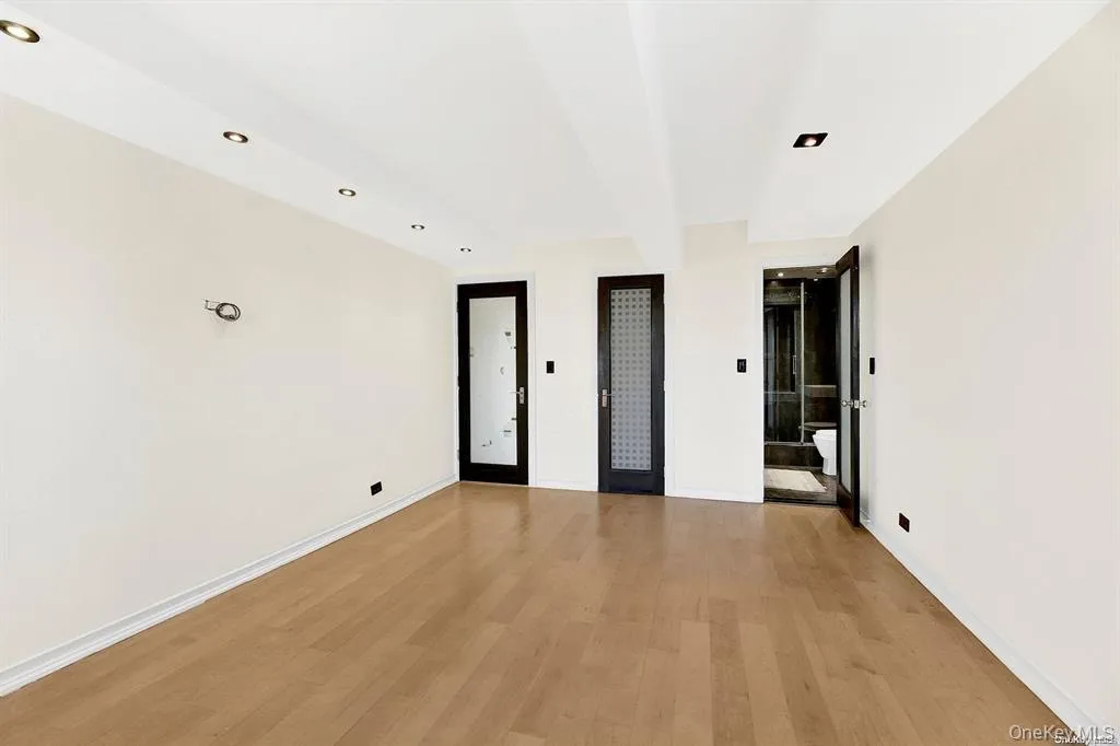 Unfurnished bedroom with light wood-style floors, recessed lighting, and beam ceiling Unfurnished bedroom with light wood-style floors, recessed lighting, and beam ceiling