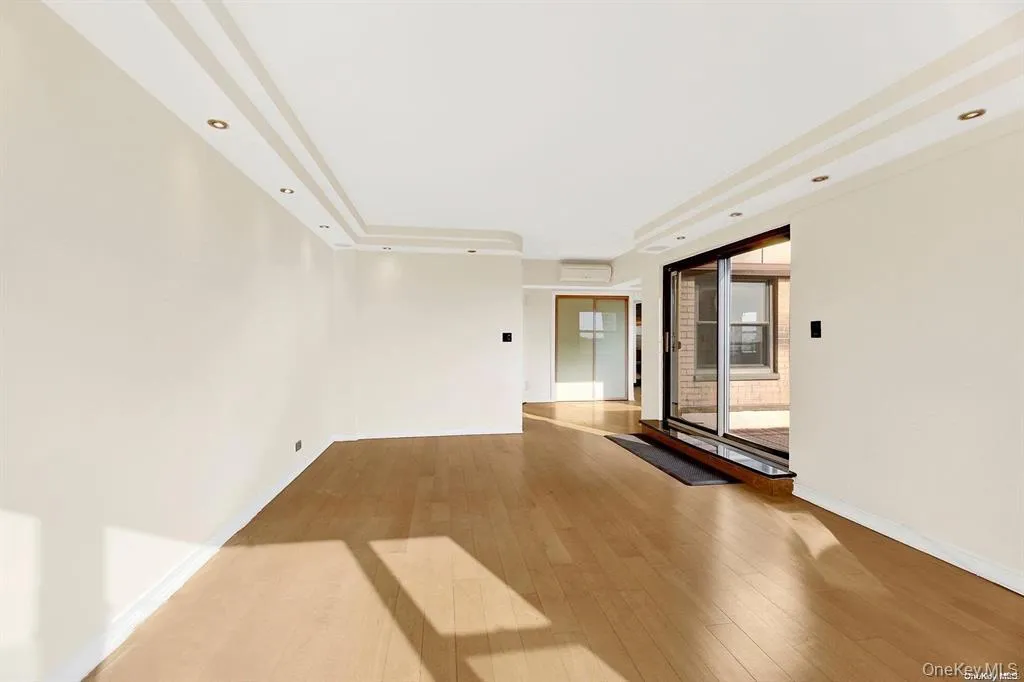 Empty room with light wood-style floors and recessed lighting Empty room with light wood-style floors and recessed lighting
